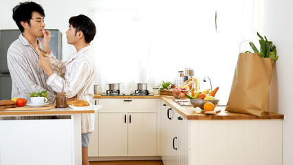 Happiness romance homosexual marriage lifestyle. Two men together love friendship. Happy gay couple enjoy breakfast in kitchen drinking coffee. Two best friends LGBTQ relation partner home cooking
