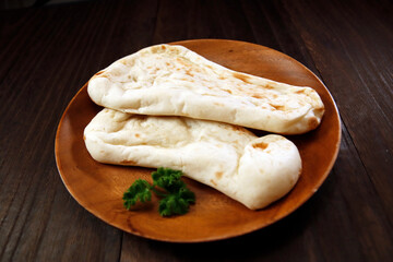 Nan made from wheat to eat with Indian curry on the table