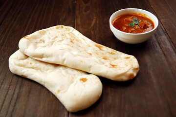 Nan made from wheat to eat with Indian curry on the table