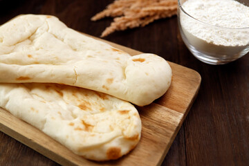 Nan made from wheat to eat with Indian curry on the table