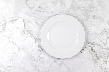 Dinner plate on a white and grey marble surface