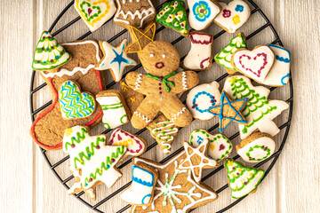 Obraz na płótnie Canvas gingerbread man cookie in the middle of christmas glazed gingerbread cookies, stars, trees, hearts and boots