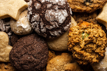 close up of christmas cookies, with chocolate, ginger, sugar, walnut, powdered sugar on wooden table