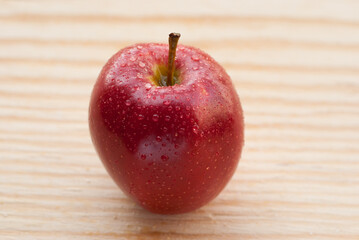 wet apple on wood table