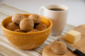 yellow bowl full of brazilian cheese bread and black coffee - pao de queijo integral - Brazilian Food - cafe preto