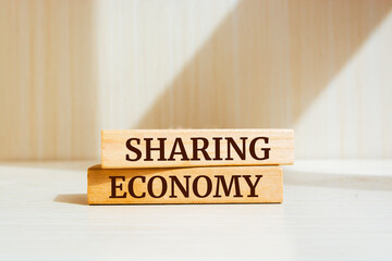 Wooden blocks with words 'Sharing Economy'. Business concept