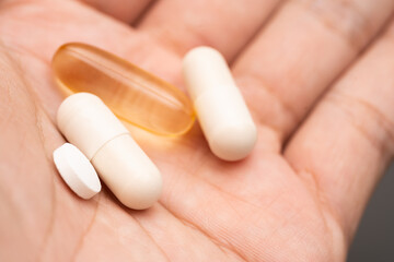Medicines and Supplements on hand. Concept for a healthy dietary supplementation. capsules of...