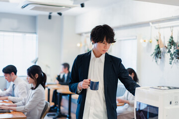 シェアオフィスでコーヒーを飲むビジネスマン