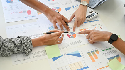 Close-up, A group of professional financial analysts voting the best financial plan for their...