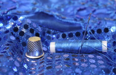 Blue Thread with needle and thimble on blue prom dress - obrazy, fototapety, plakaty