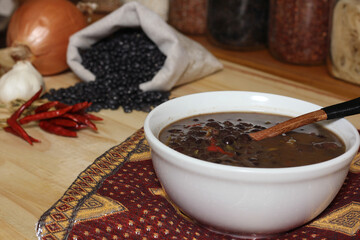 Black Bean Chili on Wooden Table With Spices and Dried Black Beans