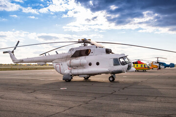 Three different helicopters at the heliport