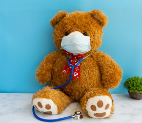 Teddy bear with a stethoscope. Teddy bear on a blue background.