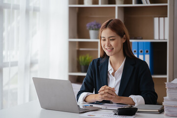 Young business women working and typing on laptop with happy and smile face on office spec.