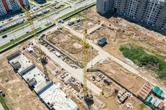 Building The Foundations On The Construction Site With Yellow Cranes. Aerial Overhead View.