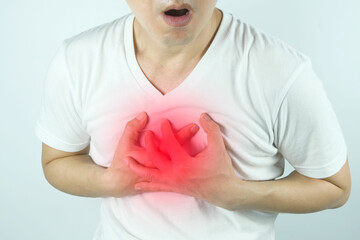 Man is sick and in pain and uses his hands to squeeze his chest He had chest pain caused by an acute heart attack. medical and health concepts