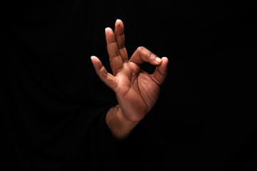 Asian male dark skinned single hand fist finger on black background ok finger sign