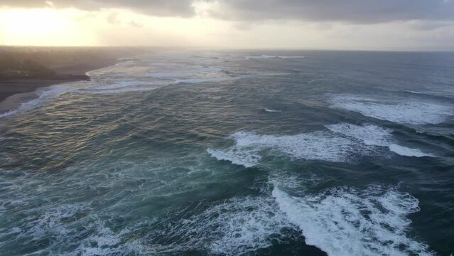 balli island indonesia , ocean aerial view of big sea waves during an epic cloudy sunset 