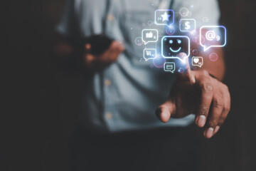 Fototapeta premium Social and digital online concepts young man using a smartphone to play social media with smiley icon 