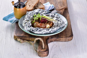 Bacon-coated grilled Camembert cheese