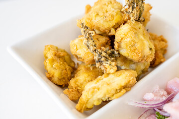 Peruvian food: chicharron de pescado or fish cracklings. White background