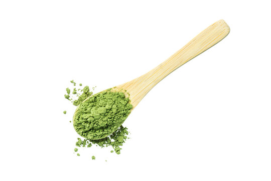 Green matcha tea powder isolated on a white background. Herbal matcha tea in a wooden spoon.