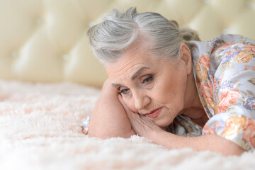 Obraz na płótnie Canvas Close up portrait of sad senior woman posing