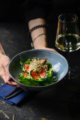 tuna salad in batter in blue plate in hands