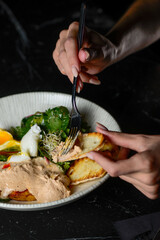 breakfast with poached egg and pate and fresh salad leaves in a plate spread pate on bread