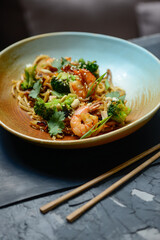 noodles with shrimp and broccoli and greens