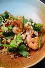 noodles with shrimps and broccoli and greens macro photo