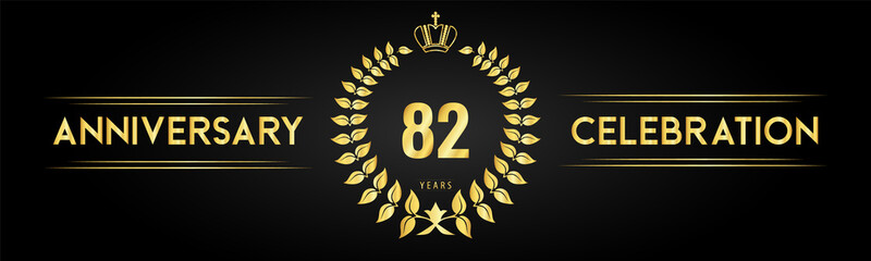 Naklejka premium 82 years anniversary celebration logo with laurel wreath and royal crown isolated on black background. Premium design for happy birthday, wedding, celebration events, greetings card, graduation.
