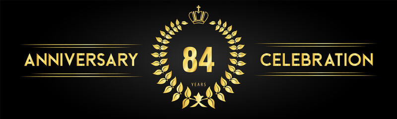 Naklejka premium 84 years anniversary celebration logo with laurel wreath and royal crown isolated on black background. Premium design for happy birthday, wedding, celebration events, greetings card, graduation.