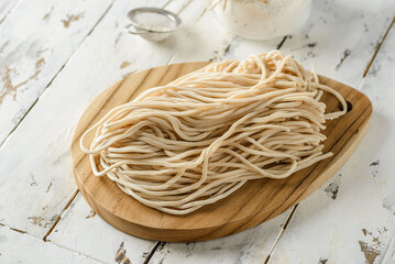 homemade noodles from dough on a board