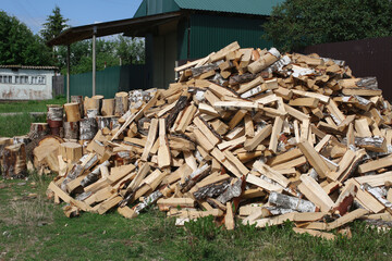 Winter preparation. Stacking Firewood. Pile of firewood loggs. Firewood background.