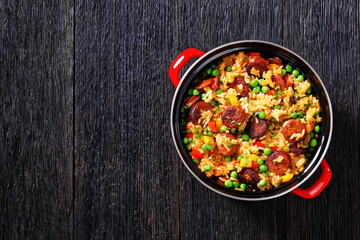 smoked sausages with rice and vegetables, top view
