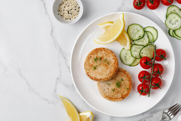 Two Cutlets, patties with tomatoes cherry, cucumbers. Healthy food dinner idea. Keto Diet. Top view.