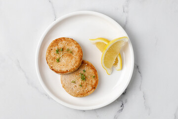 Two Baked Salmon fish or chicken cutlets on white plate. Concept keto diet healthy food. Dinner idea. Close up.