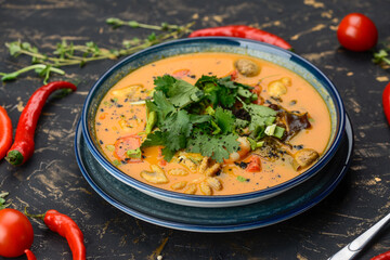 tom yum soup in a blue plate