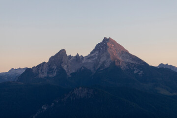travel germany and bavaria, view at the mountain Watzmann at the break of dawn, dark trees in the forground, Bavaria, Germany