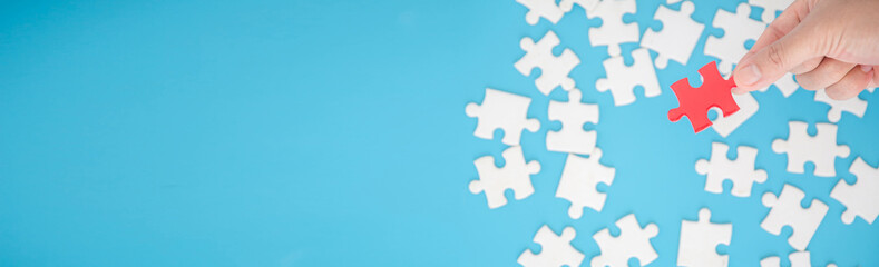 Top view of jigsaw puzzle on blue background