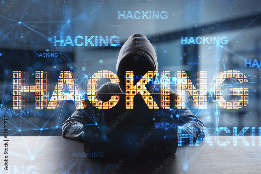 Leinwandbilder Hacking attack and cyber security concept with glowing digital yellow hacking word on hacker silhouette with laptop background, double exposure