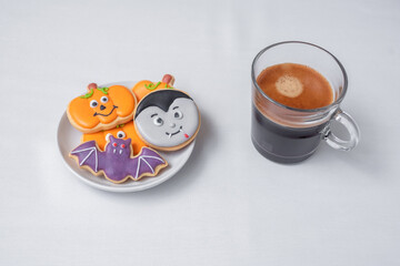 Obraz na płótnie Canvas hot espresso coffee or chocolate cup with funny Halloween Cookies. Happy Halloween day, Trick or Threat, Hello October, fall autumn, Traditional, party and holiday concept