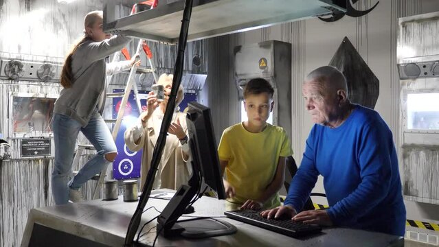Grandson together with his grandfather solve the riddles of the quest room. High quality 4k footage