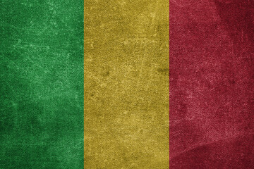 Old leather shabby background in colors of national flag. Mali
