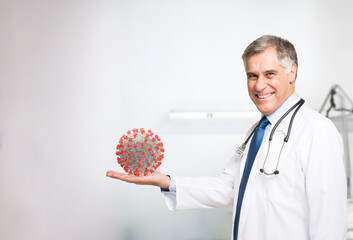 Doctor holding a virus in his hand, covid concept