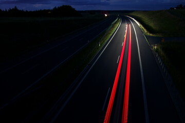 Fototapeta na wymiar Night traffic on a motorway. Speed, colours, perspective