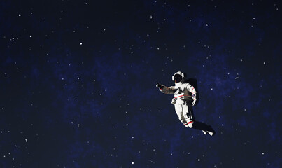 Fototapeta na wymiar Astronaut spacewalk in space and pointing his finger.