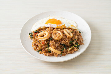 fried rice with squid and basil topped fried egg in Thai style