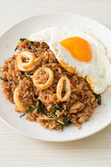 fried rice with squid and basil topped fried egg in Thai style